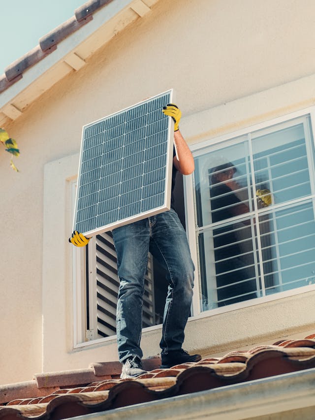 A man installing a solar panel